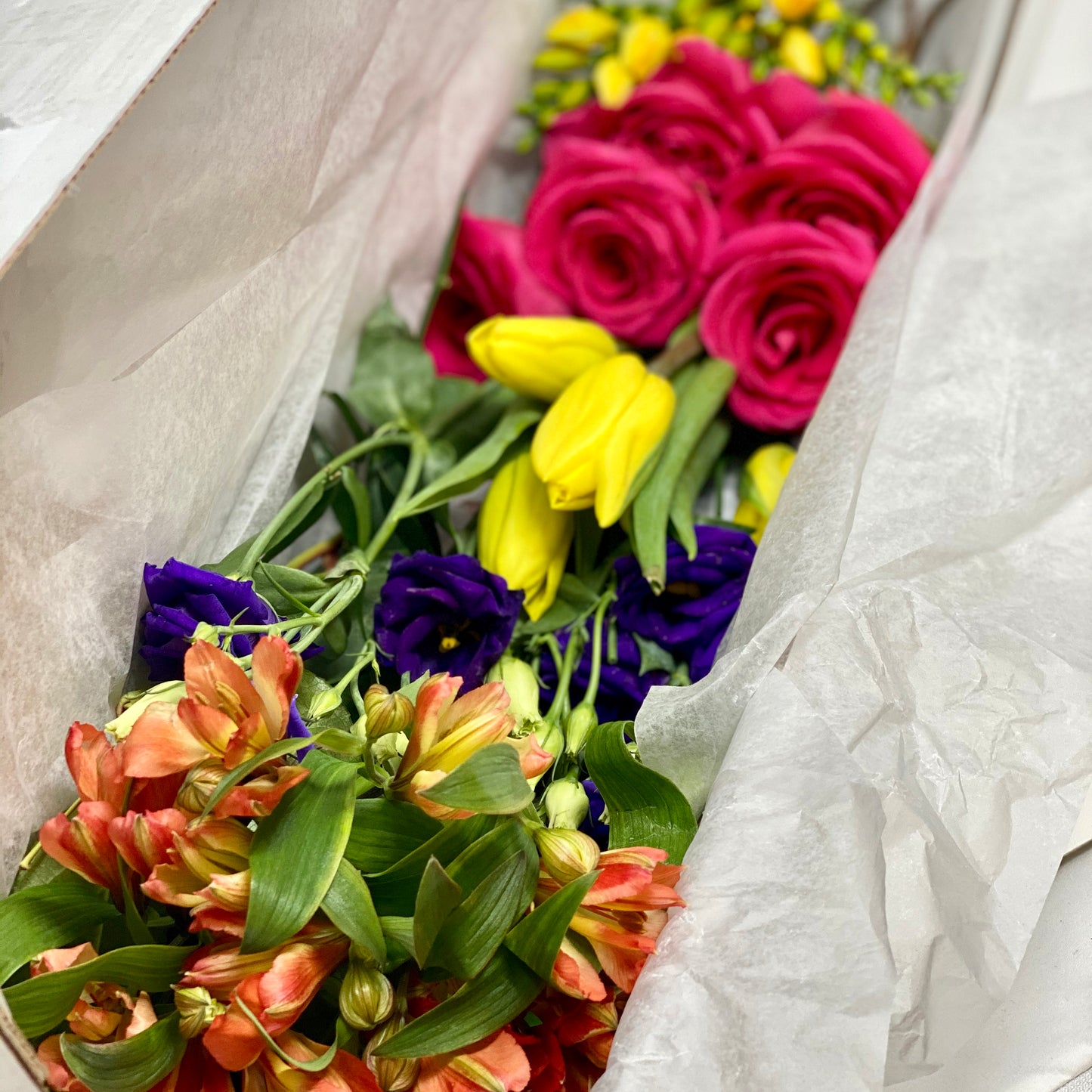 DIY Flower Box with bright pink, bright yellow, bright purple flowers and greens
