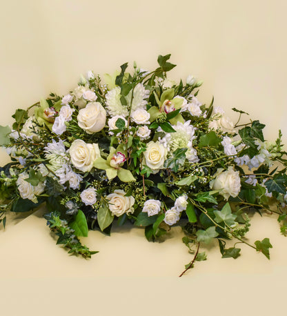 Casket spray white and green flowers of mixed types