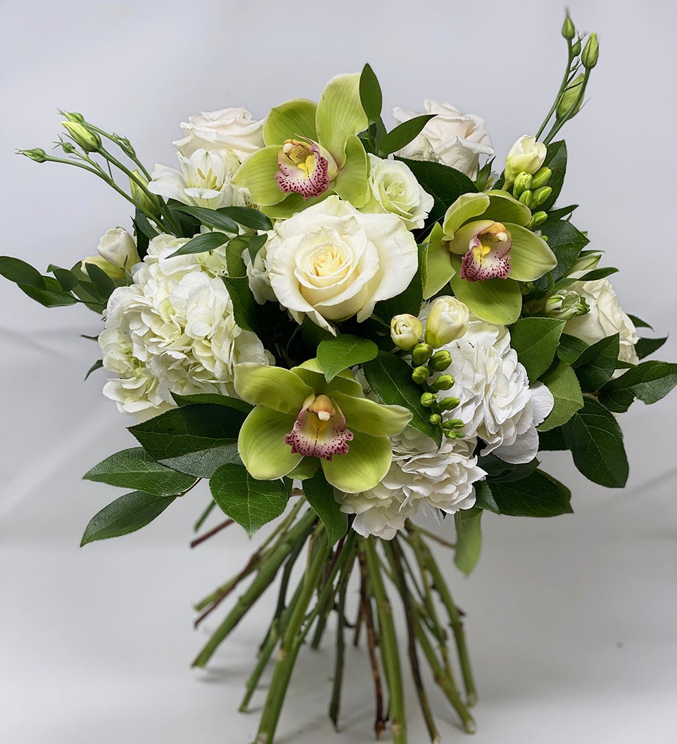 White and green flowers arranged in a bouquet for a flower subscription