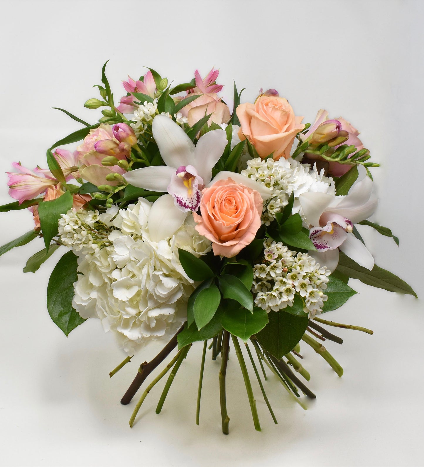 Bouquet with peach and light pink flowers and white hydrangea
